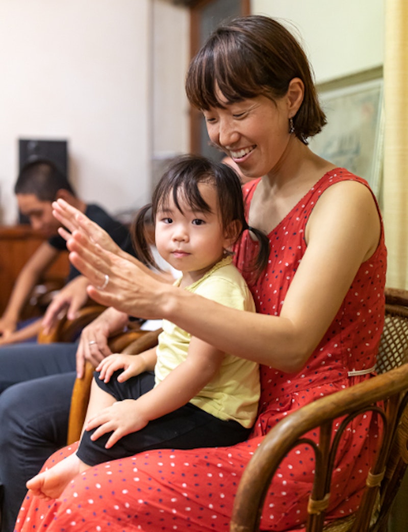 child sits on mother's laps